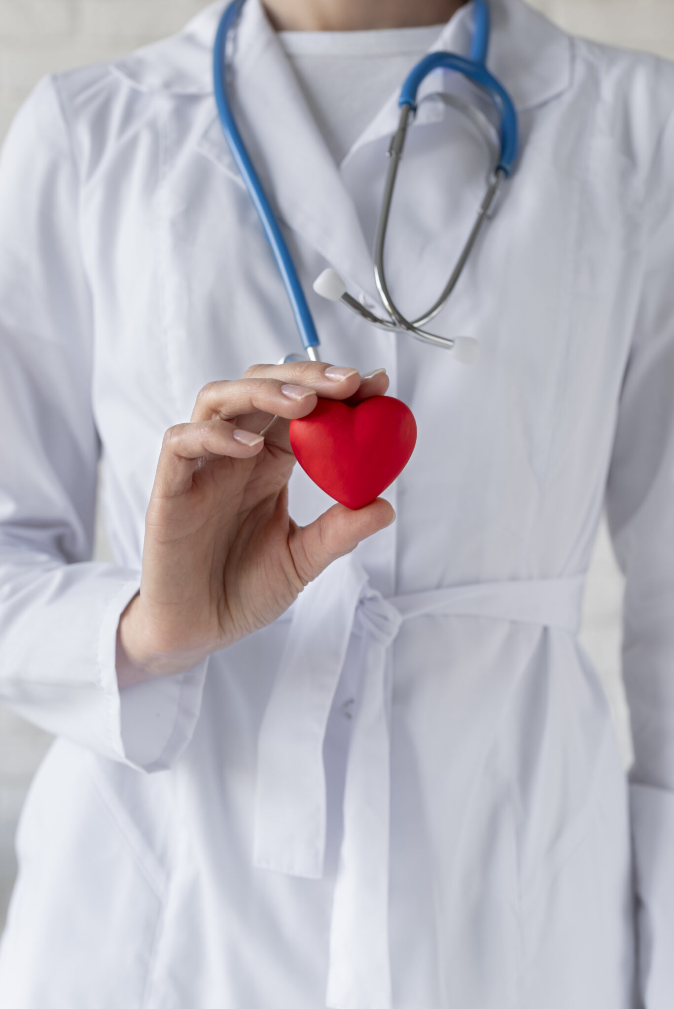 close up doctor holding red heart