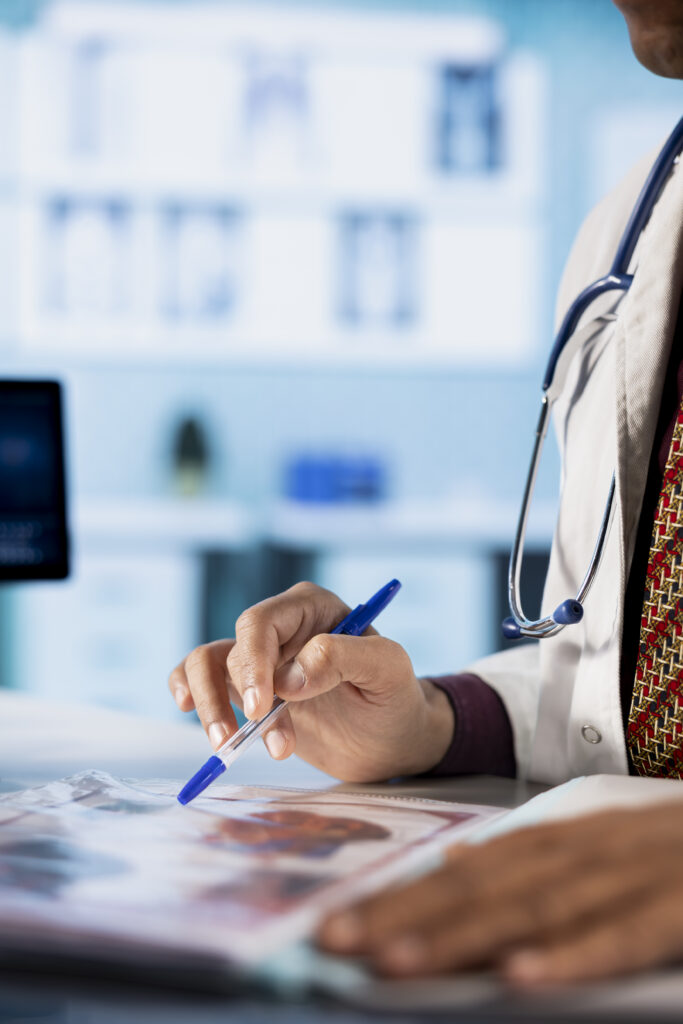 general practitioner consulting patient and reviewing x ray test results